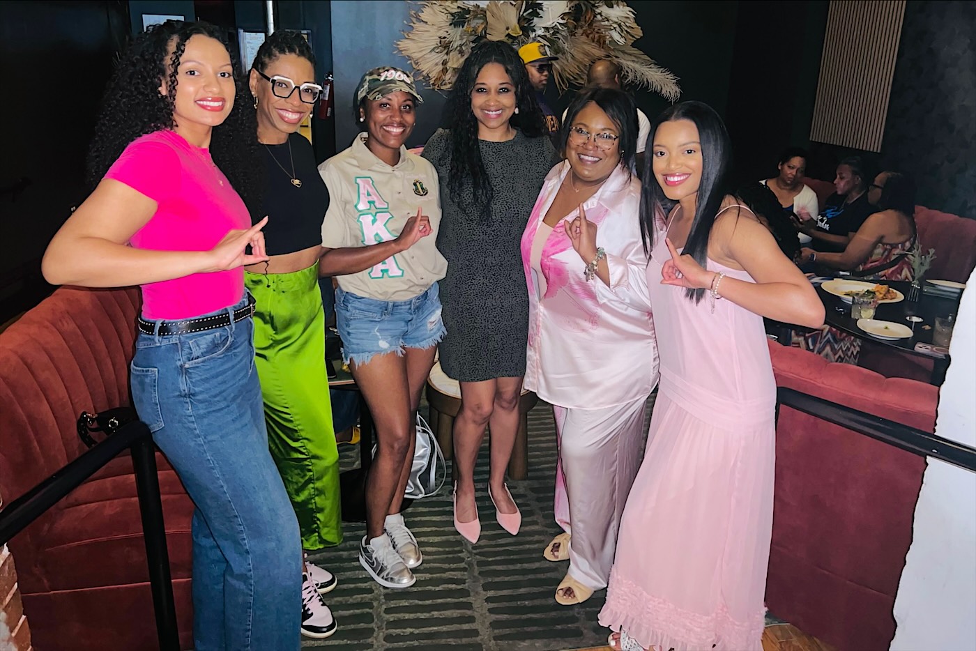 Six sorors in pink and green on a night out